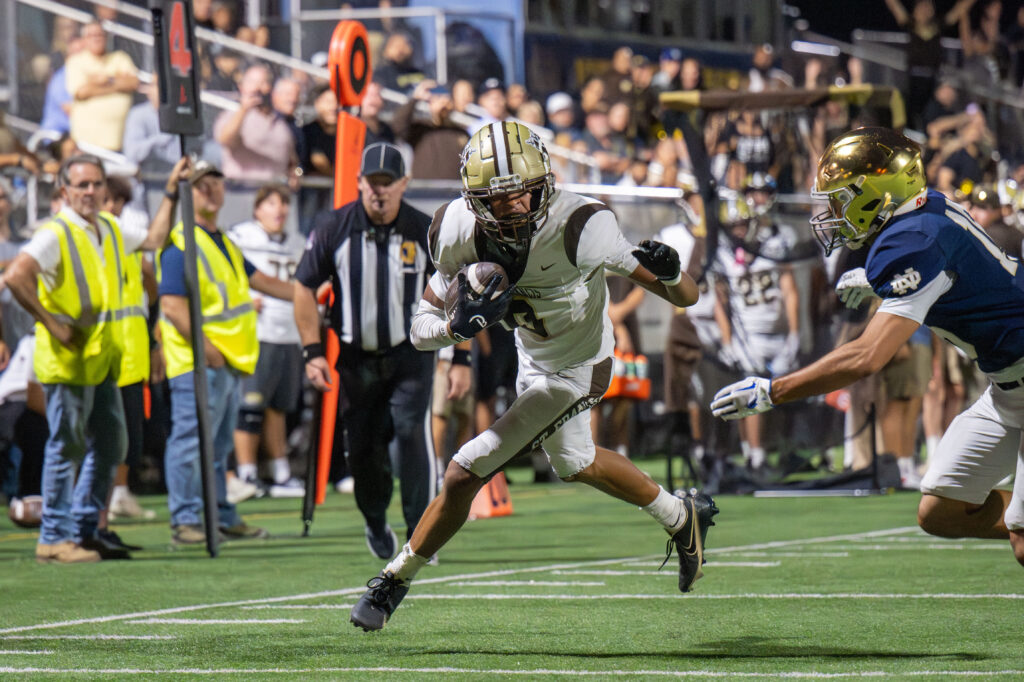 Mason Maddox #9 makes a touchdown against Notre Dame.
